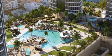 resort complex with sky view of luxurious swimming pool and palm trees